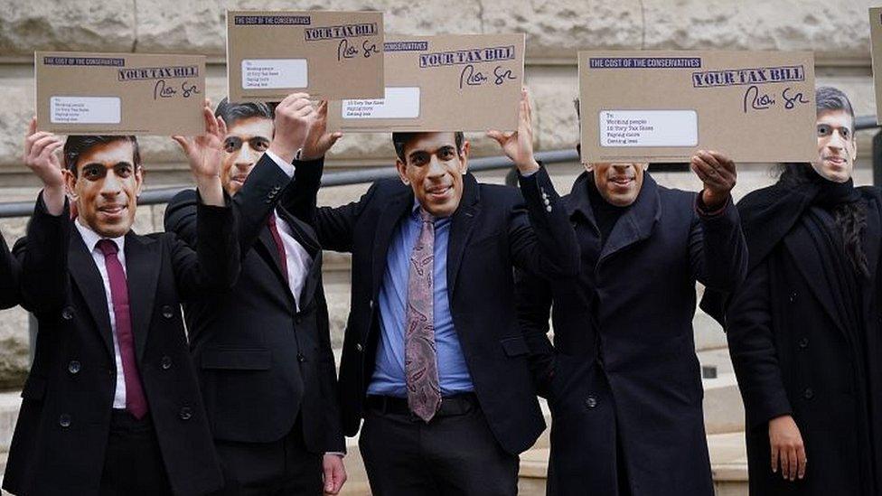 Protesters in Rishi Sunak masks