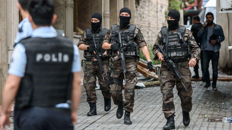 Turkish special force police officers secure area around the site of a bomb attack that targeted a police bus in Istanbul