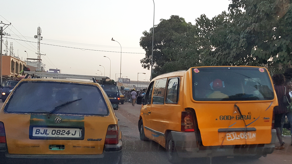 Vehicles travelling on the pavement in The Gambia