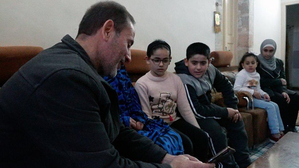 Palestinian Hebron resident Yasser Abu Markhiya (L) and his family