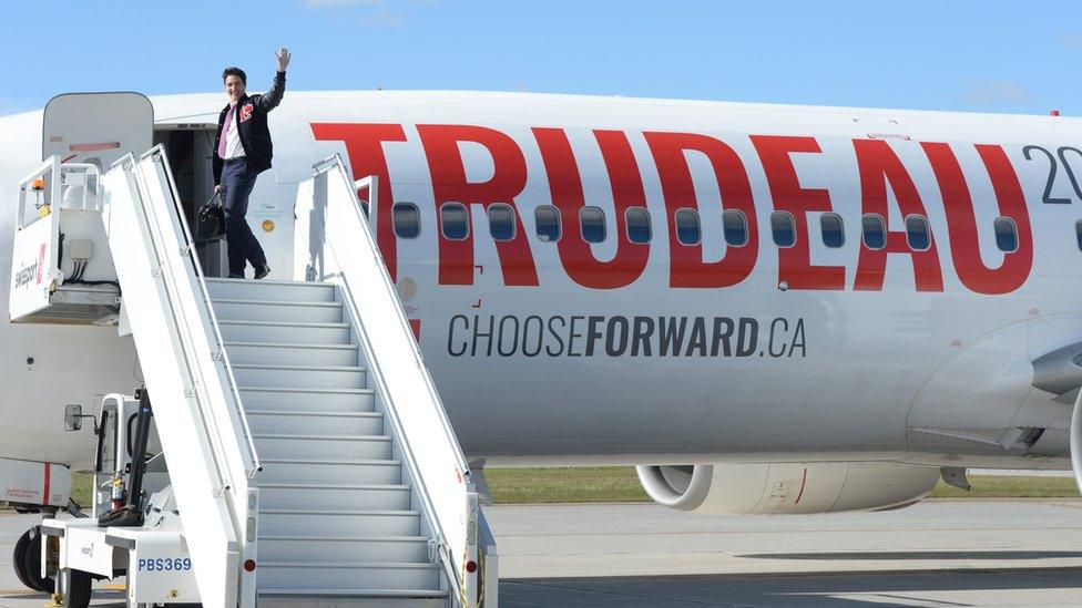 Liberal leader Justin Trudeau enters one of his campaign planes