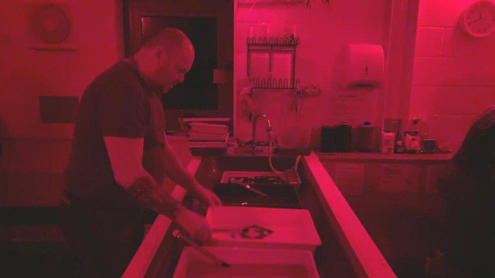 Man processing a photograph at a darkroom in Bristol