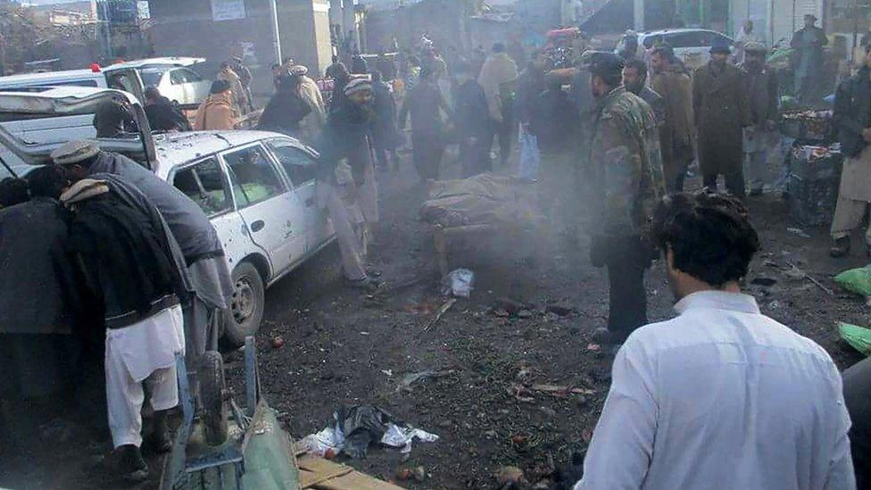 Pakistani security officals and local residents gather at the site of a bomb explosion at a vegetable market in Parachinar city, the capital of Kurram tribal district on the Afghan border on January 21, 2017.