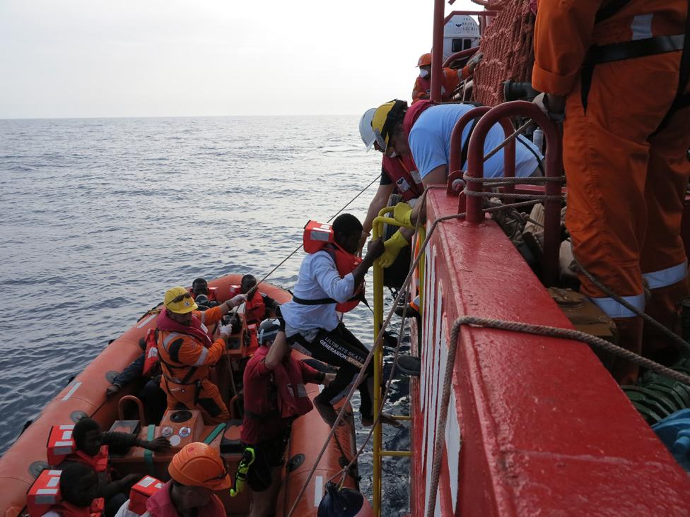 Man scrambles aboard rescue ship