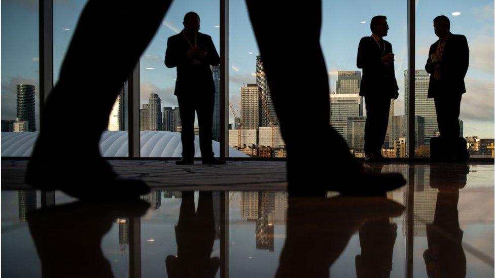 Men against City of London backdrop