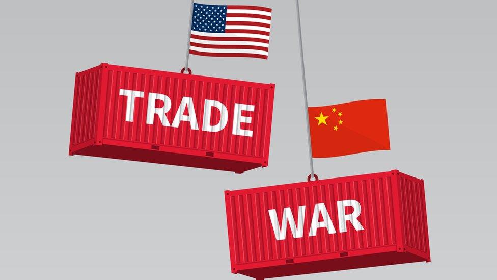 US and China shipping containers that read 'trade' and 'war' on their sides