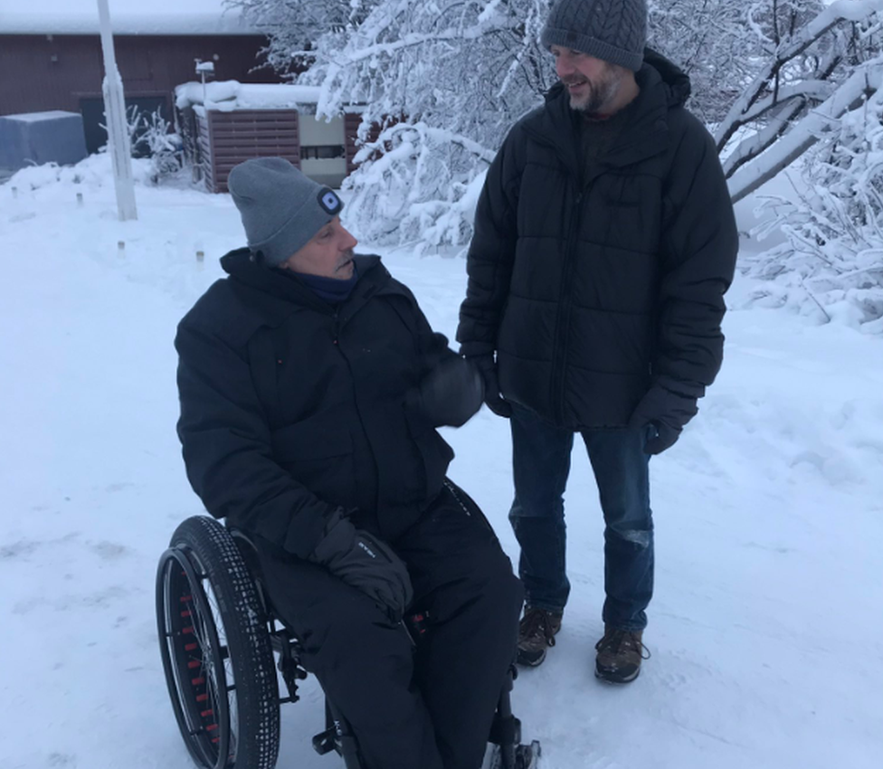 man in wheelchair in the snow