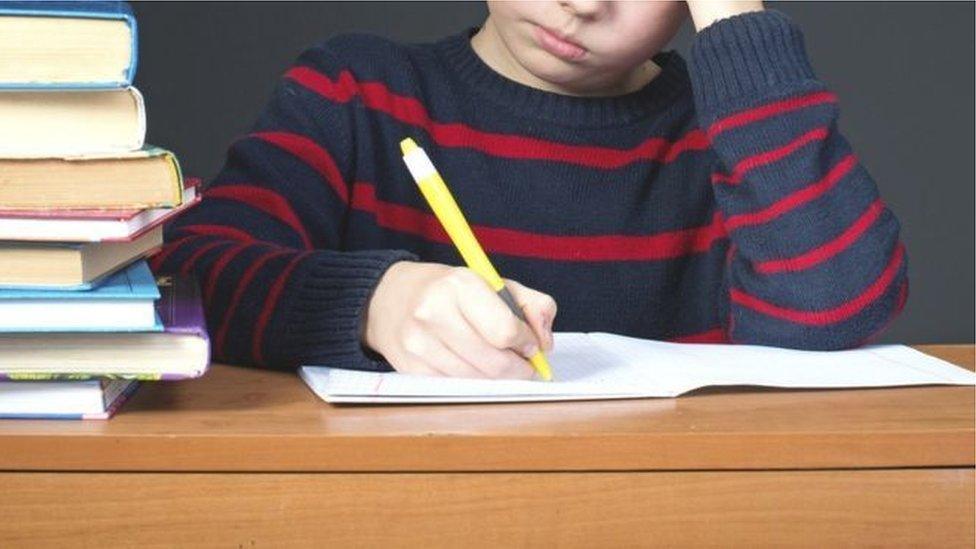 A child using a colouring pen