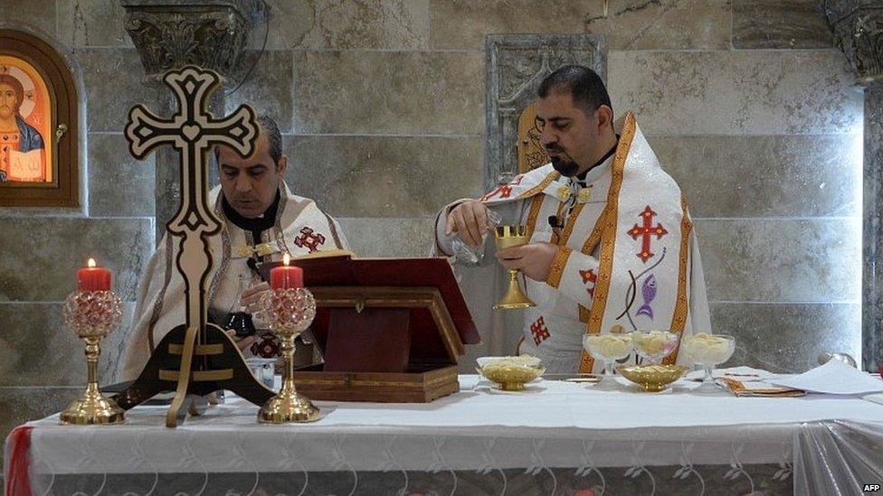 Iraqi priests lead Christmas Eve Mass at the Saint Jacob Church in Mosul