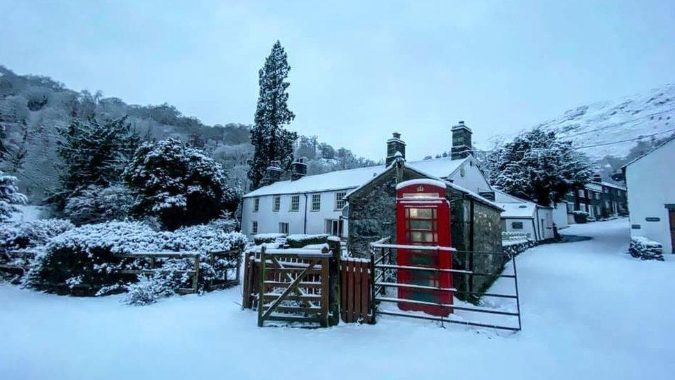 Phone box in snow in village