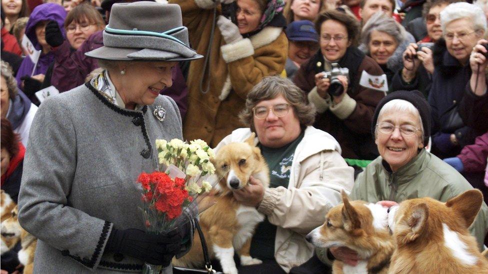 Queen Elizabeth II talks with members of the Manitoba Corgi Association during a visit to Winnipeg, 8 October 2002.