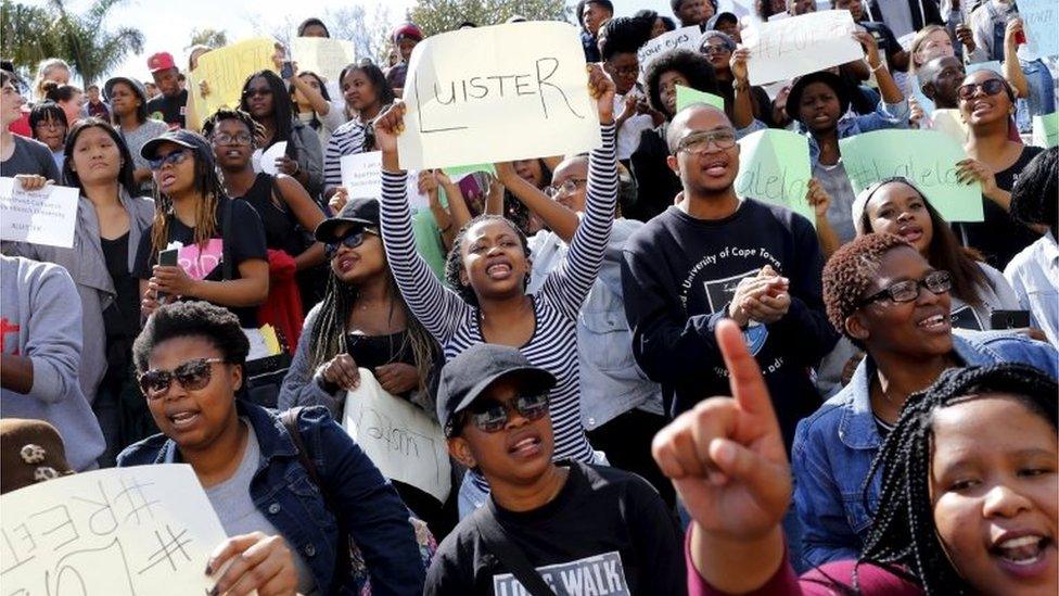 A student (C) holds up a sign that reads "Listen" during a protest at South Africa"s Stellenbosch University in Stellenbosch, in this picture taken September 1, 2015.