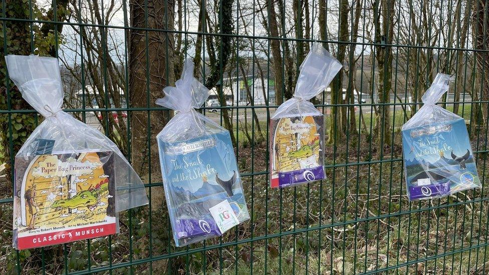 Books tied to fence