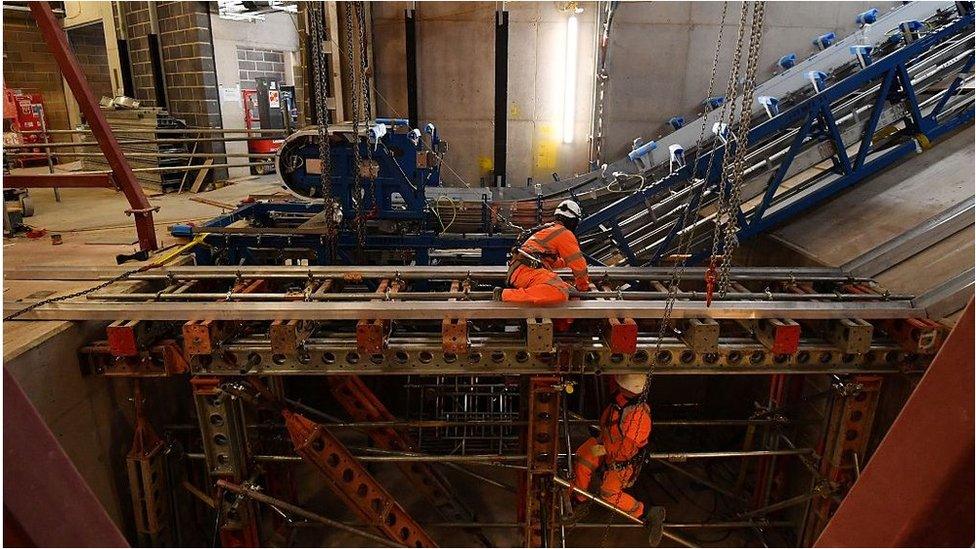 Workmen installing escalators on Crossrail