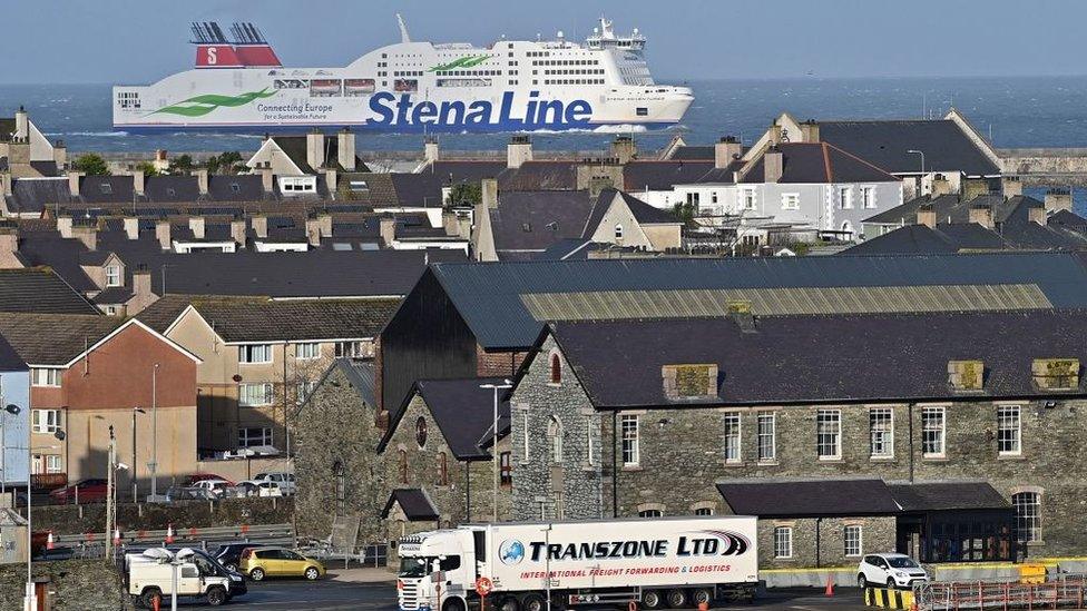 Holyhead with Stena Line ferry at sea and lorry driving from port in foreground