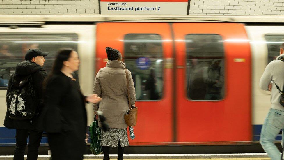 People waiting on platform as Tube arrives