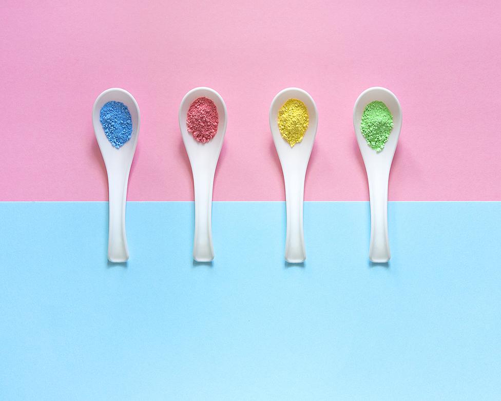 Crushed pastels lined up in plastic spoons