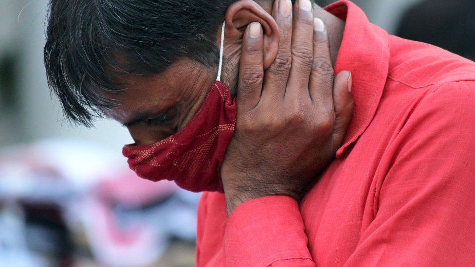 A man wearing facemask as a preventive measure against the Covid-19 coronavirus wait in a long queue to enter Rajiv Chowk Metro Station in New Delhi on September 18, 2020.