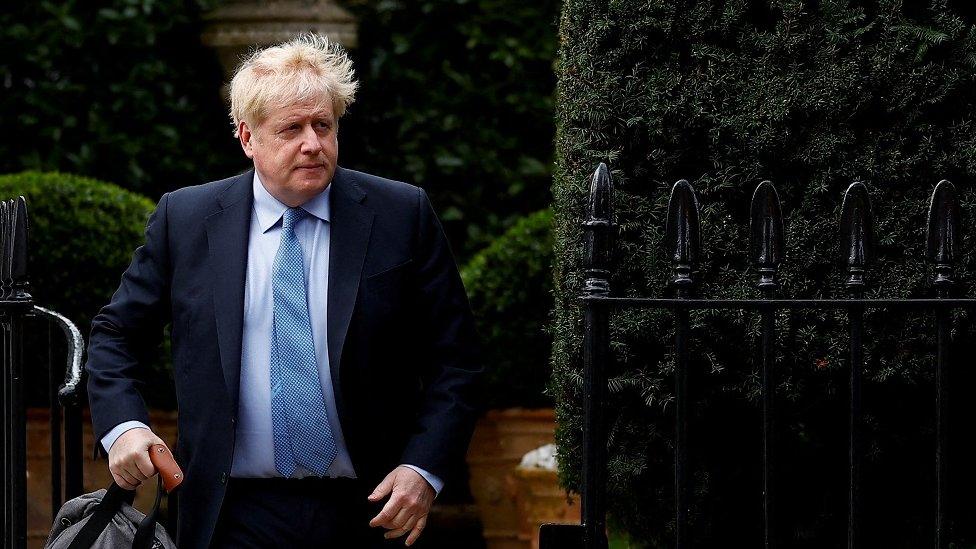 Former British Prime Minister Boris Johnson walks outside his home in London