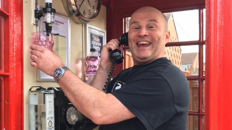 Lee Copeland inside his converted red phone box