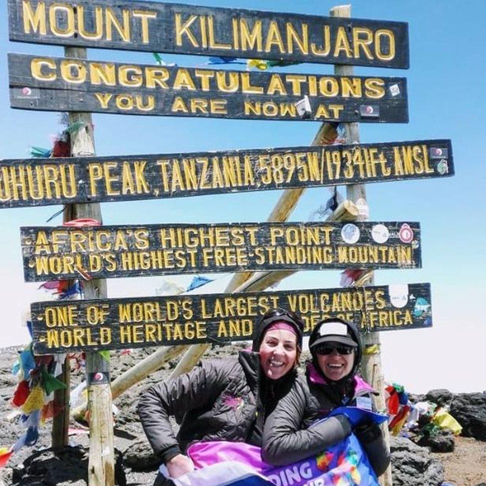 Corinne Hutton (r) at the top of Mount Kilimanjaro.