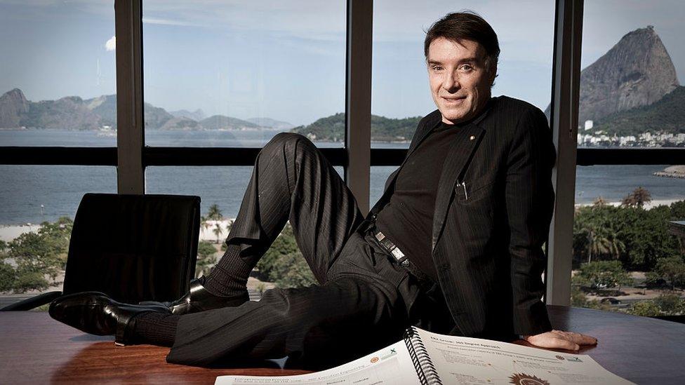 Eike Batista atop his desk