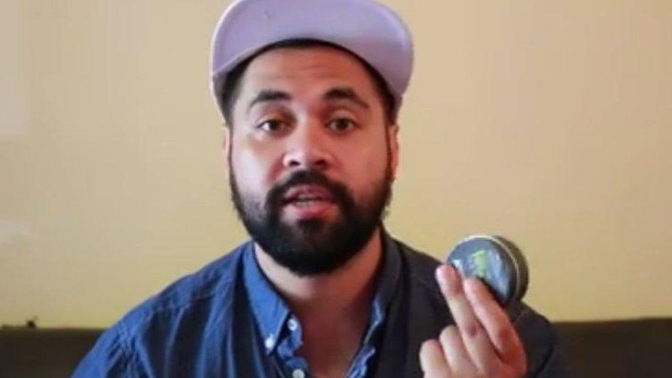 Actor Bjorn Stewart in “How to do blackface” makeup tutorial holding a pot of shoe polish