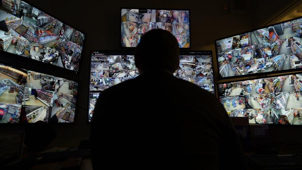 Filco's new CCTV system comprising of lots of screens with a silhouette of a person sat in front of them