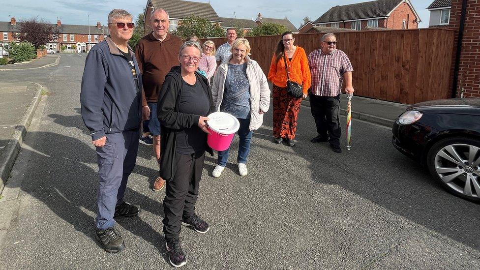 Julie Dervey, centre, with a collection bucket for the 'cross the road' fundraiser in Hedon