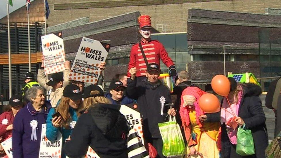 Crowd at protest with banners