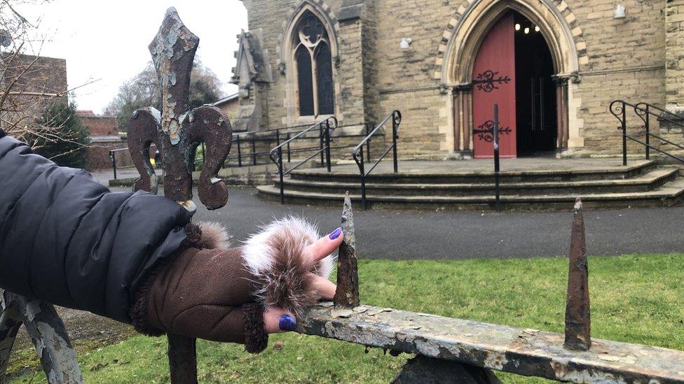 Rev Canon Sue Sheriff standing in front of spikey railings