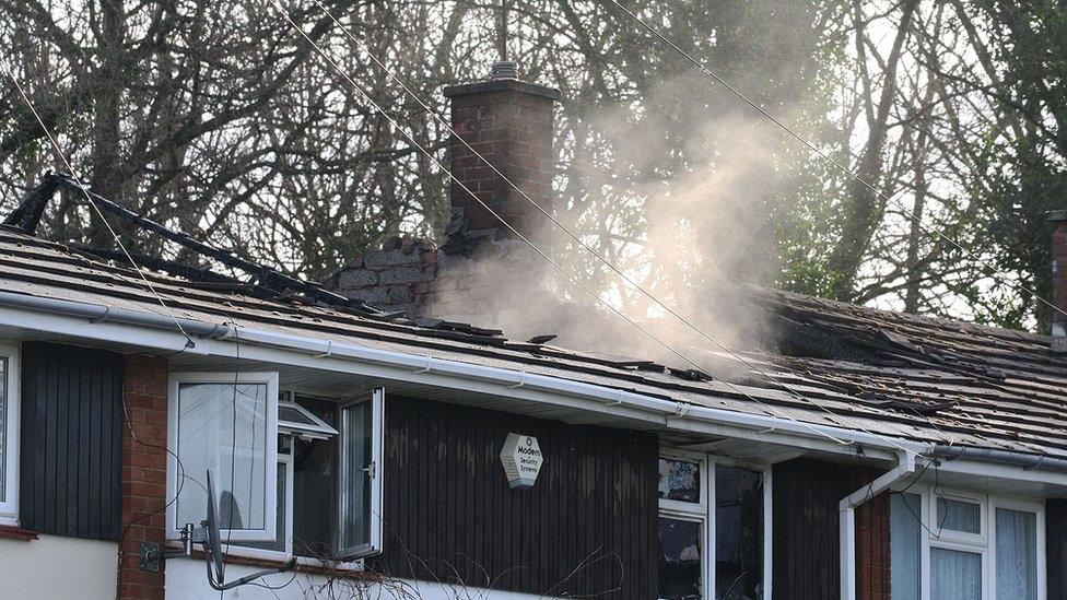 Smoke coming through a building's roof