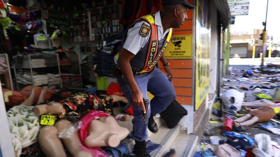 A police officer is seen during as looting and violence erupts on September 02, 2019 in Johannesburg, South Africa. Shops in and around various parts of Johannesburg, were looted and set alight