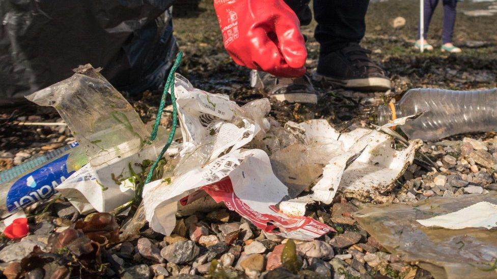 Beach waste being gathered