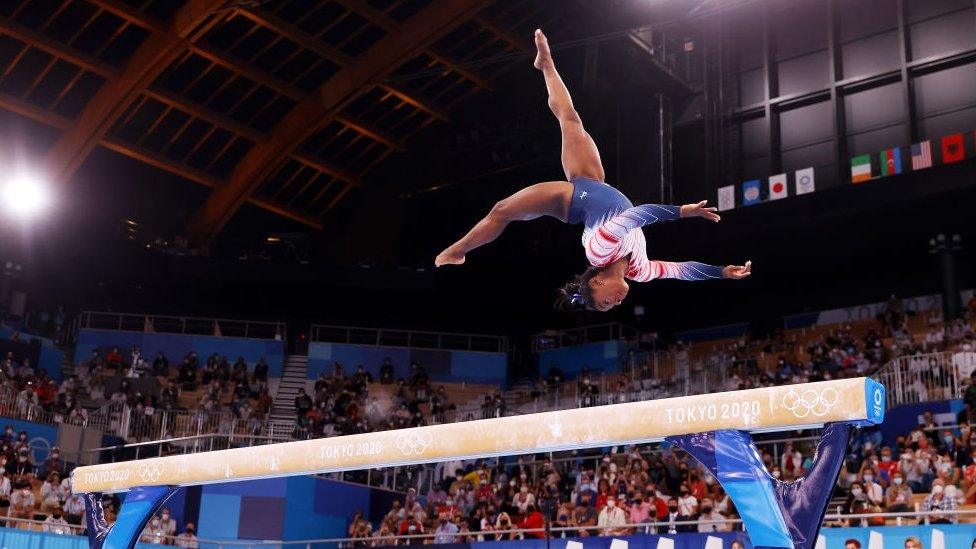 Simone Biles competing in the Women's Balance Beam Final at the Tokyo Olympics