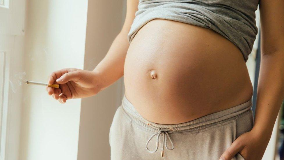 Pregnant woman with cigarette