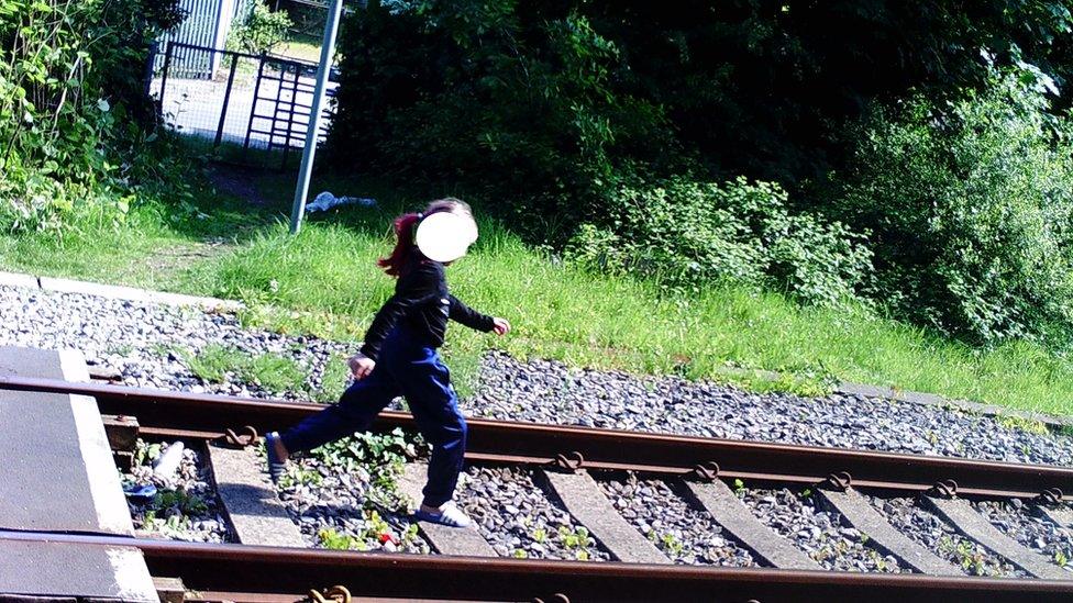 A woman was caught walking along the track in Skewen