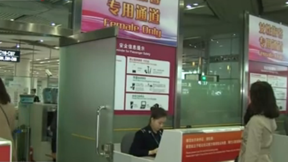 A woman at the Beijing airport women's security check