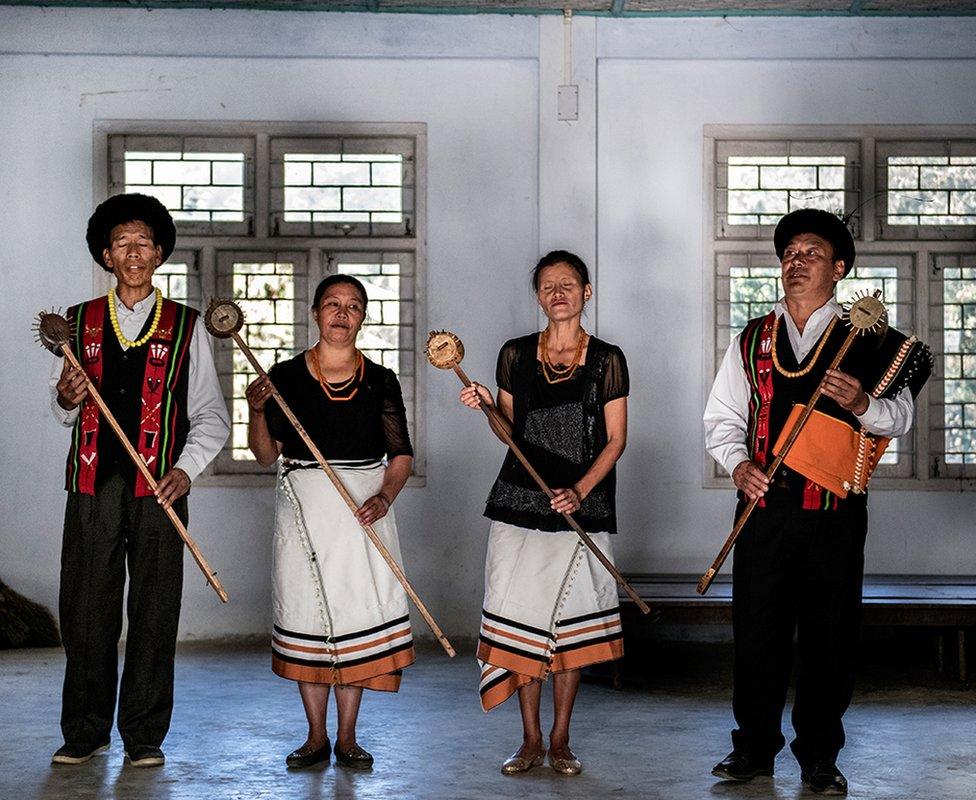 The village members are seen practicing folk music.