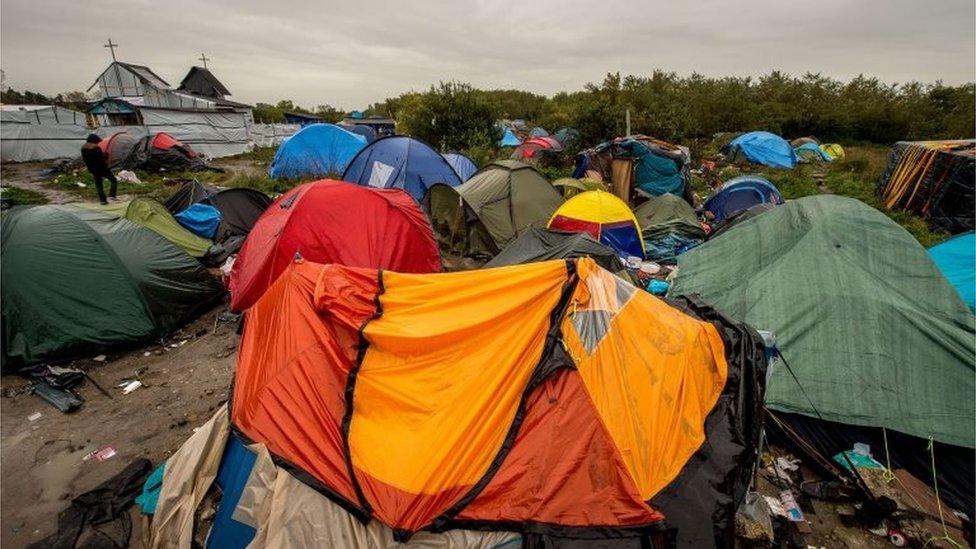 Migrants" tents are pictured in the "New Jungle" migrant camp in Calais, where thousands of migrants live in the hope of crossing the Channel to Britain, on 21 October 2015.