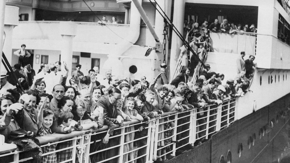 Jewish refugees aboard the MS St. Louis ocean liner wave as they arrive in Antwerp, Belgium.