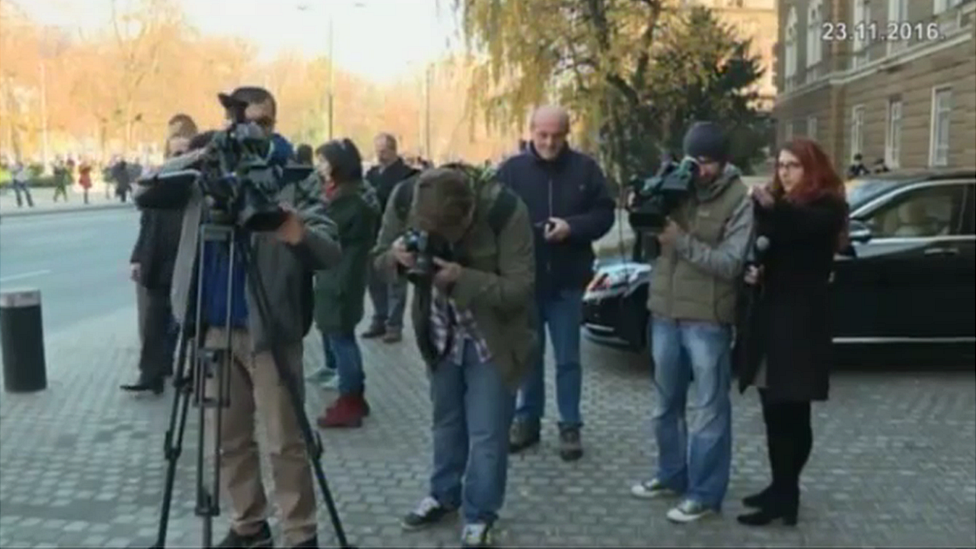 Journalists and cameramen standing on the pavement