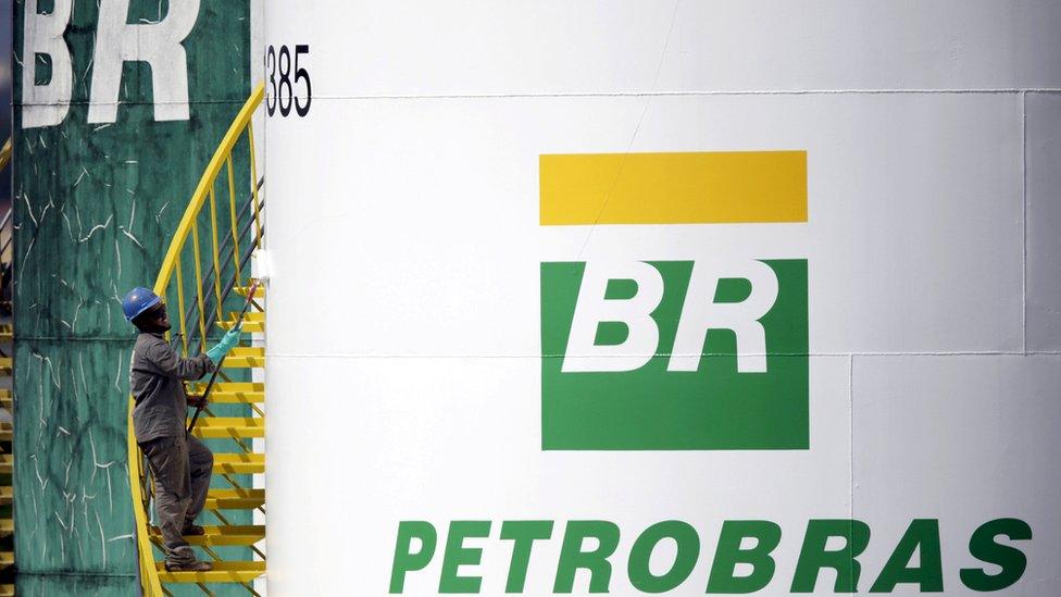 Worker painting Petrobras tank