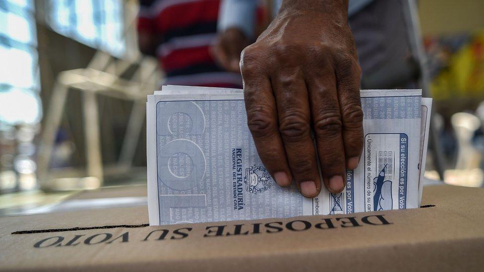 A man casts his vote at a polling station in Cali, Valle del Cauca Department, during parliamentary elections in Colombia on March 11, 2018.