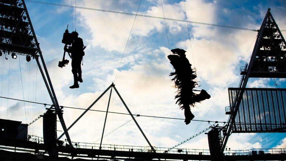 Cameraman and performer inside stadium