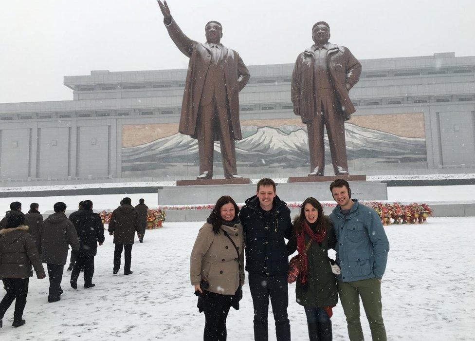 Otto Warmbier and friends pose in front of statues in North Korea