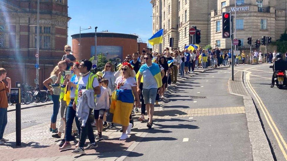 Ukrainians in Bristol march in protest against a rocket attack that killed prisoners of war.