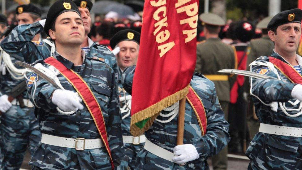 Troops of Georgia's rebel region of Abkhazia march during a military parade to mark the 20th anniversary of Abkhazia's de facto independence