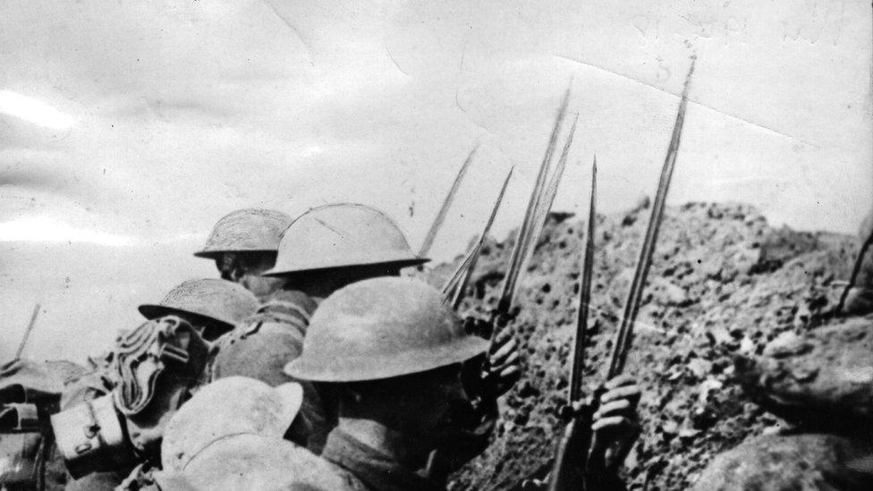 WW1 soldiers fix bayonets before going over the top