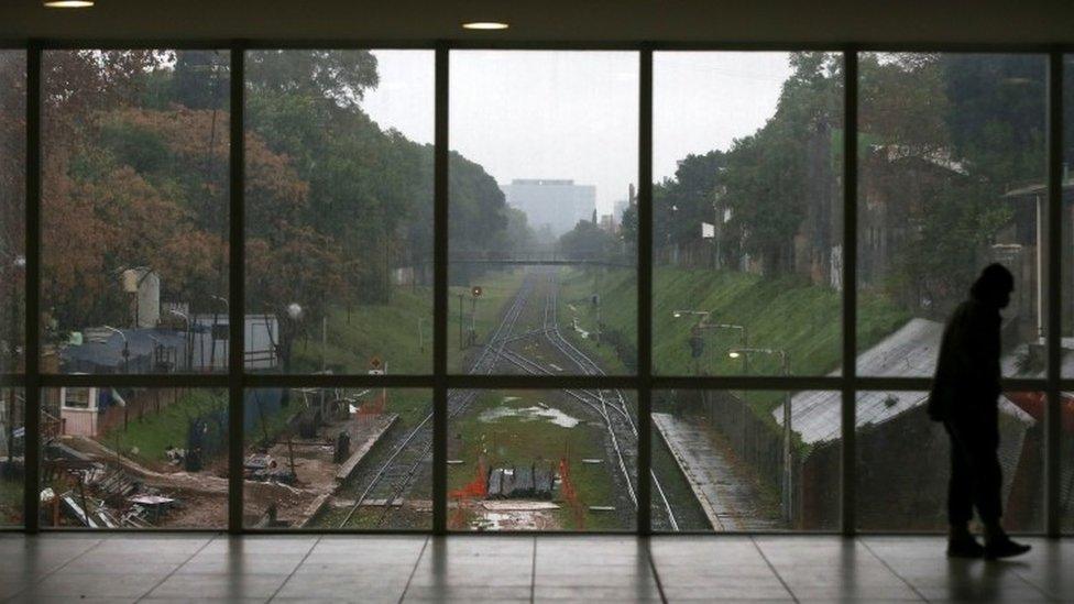 A man stands in a train station during a blackout in Argentina